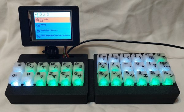 A Japanese-input macro pad with a display and color-coded light-up keys.